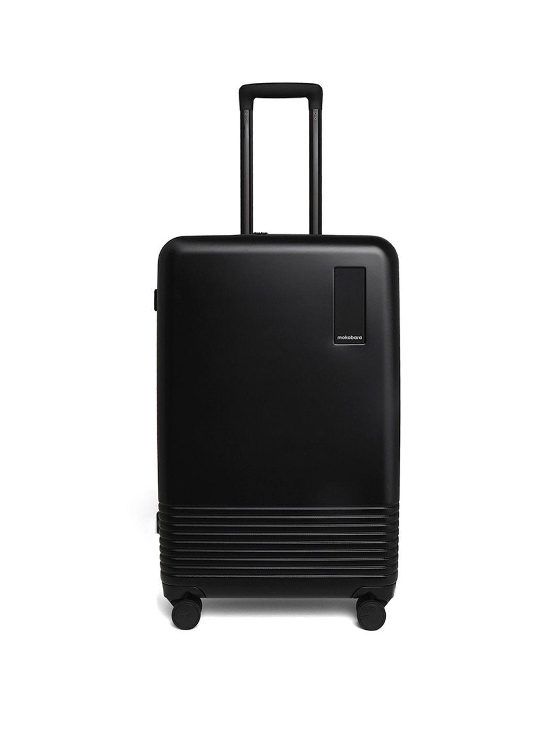 mokobara black textured hard-sided medium trolley suitcase