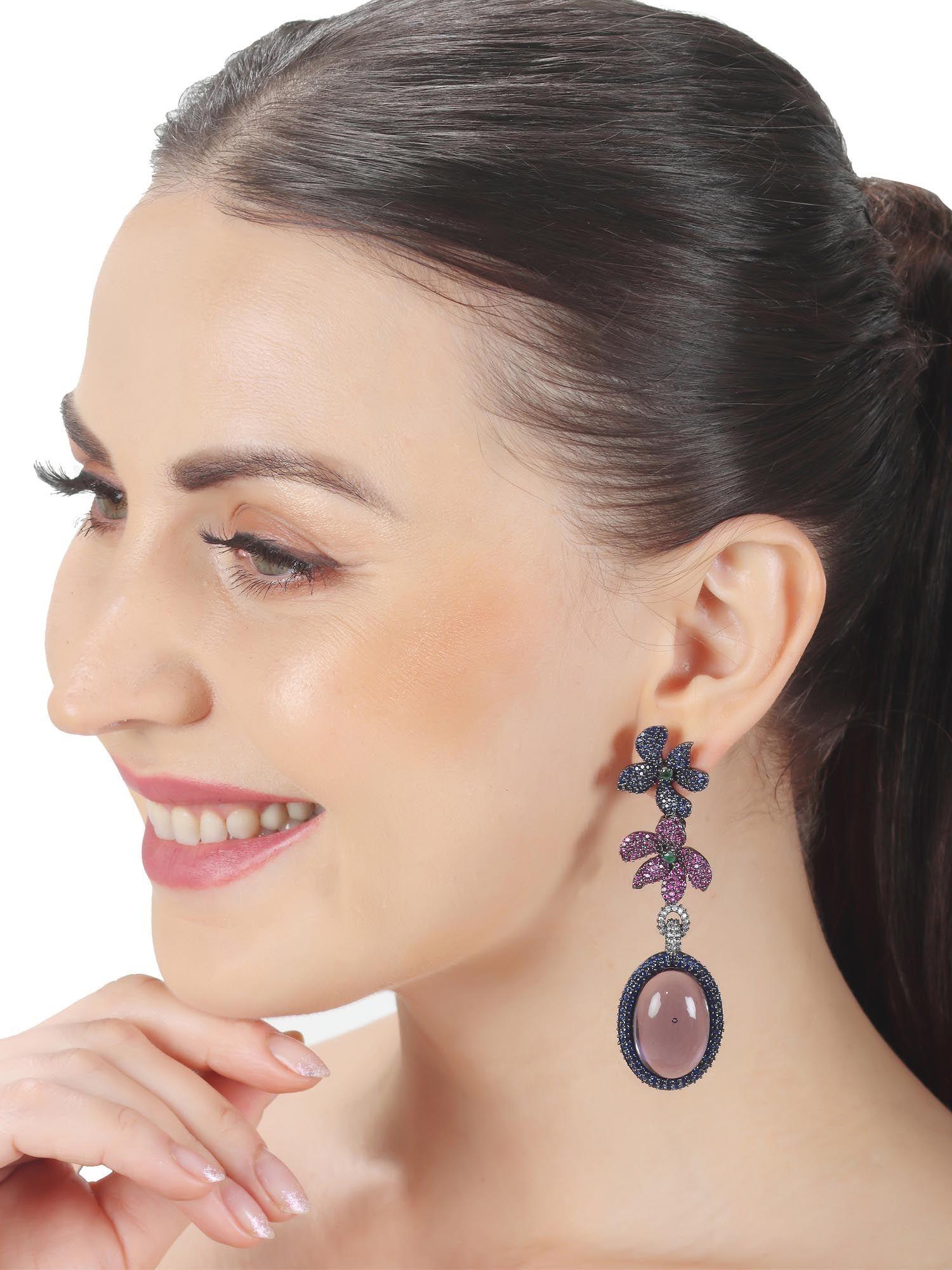 navy blue doublet earrings with a floral motif