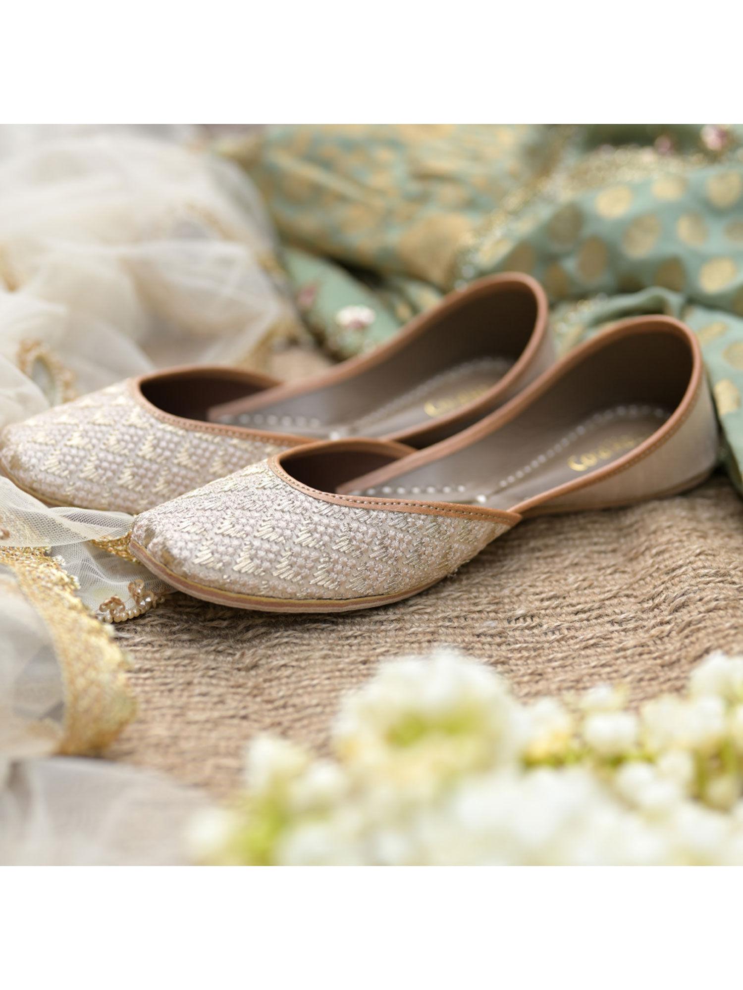 nude ivory colored juttis with zari and thread work