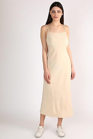 nude slip dress with shell buttons