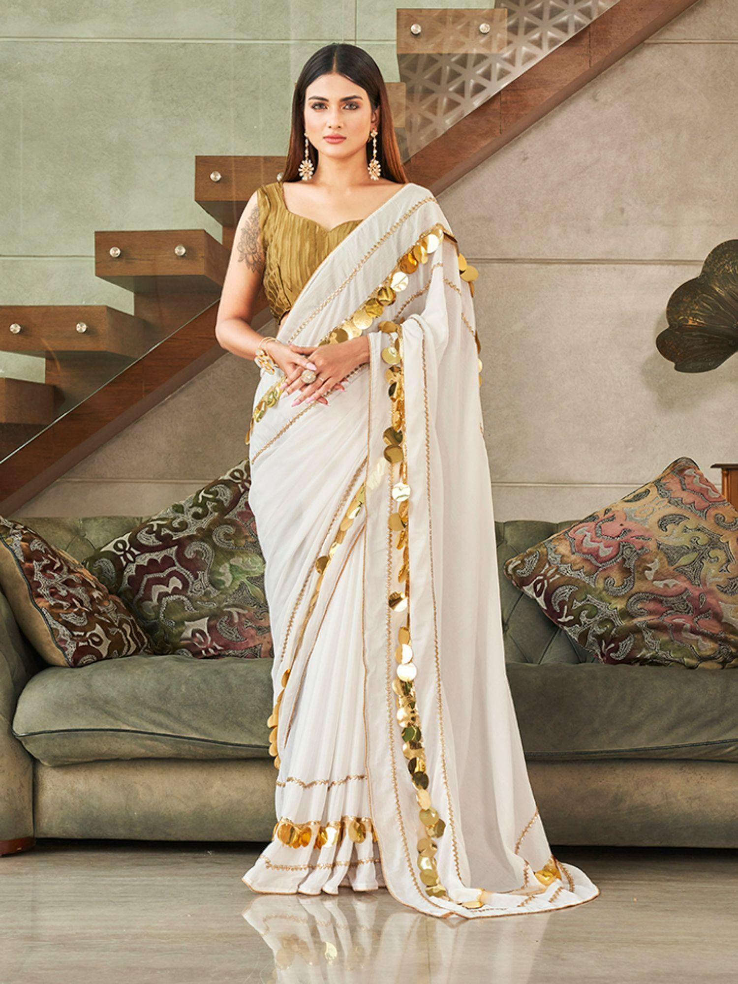 off white colored sequinned lace saree with unstitched blouse