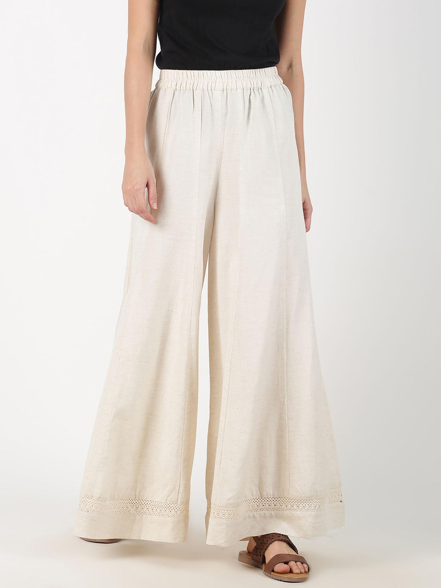 off white solid flared palazzos with lace inserts on hem