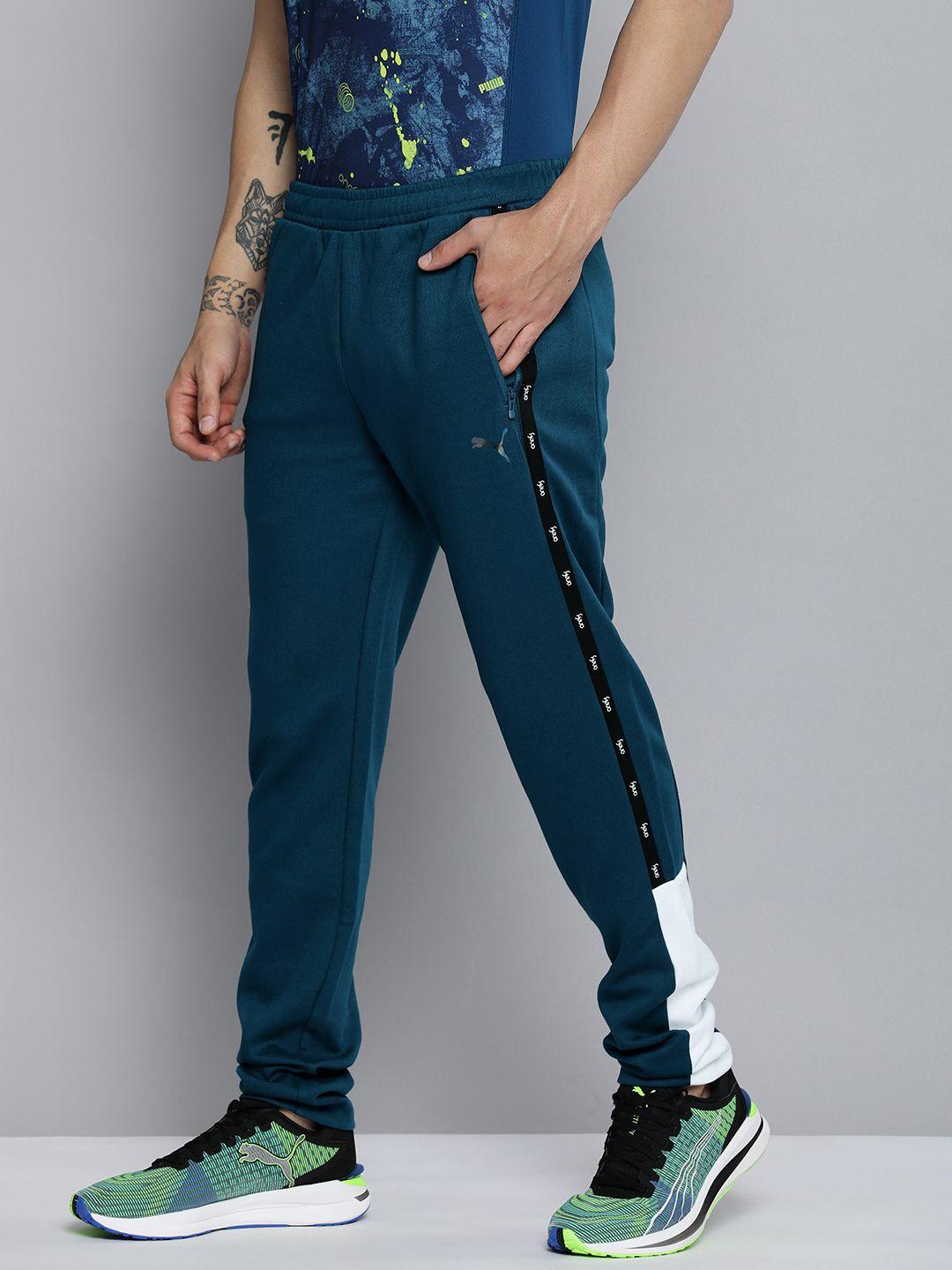 one8 x puma men teal blue colourblocked virat kohli woven track pants with side stripes