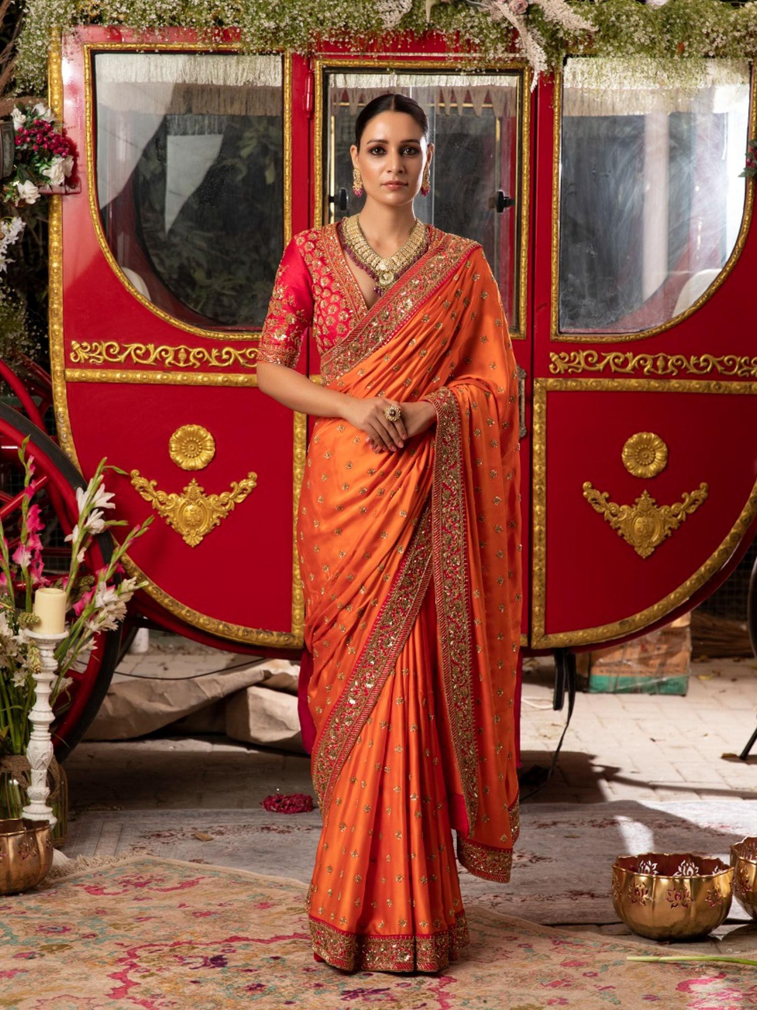 orange embroidered saree with stitched blouse and petticoat