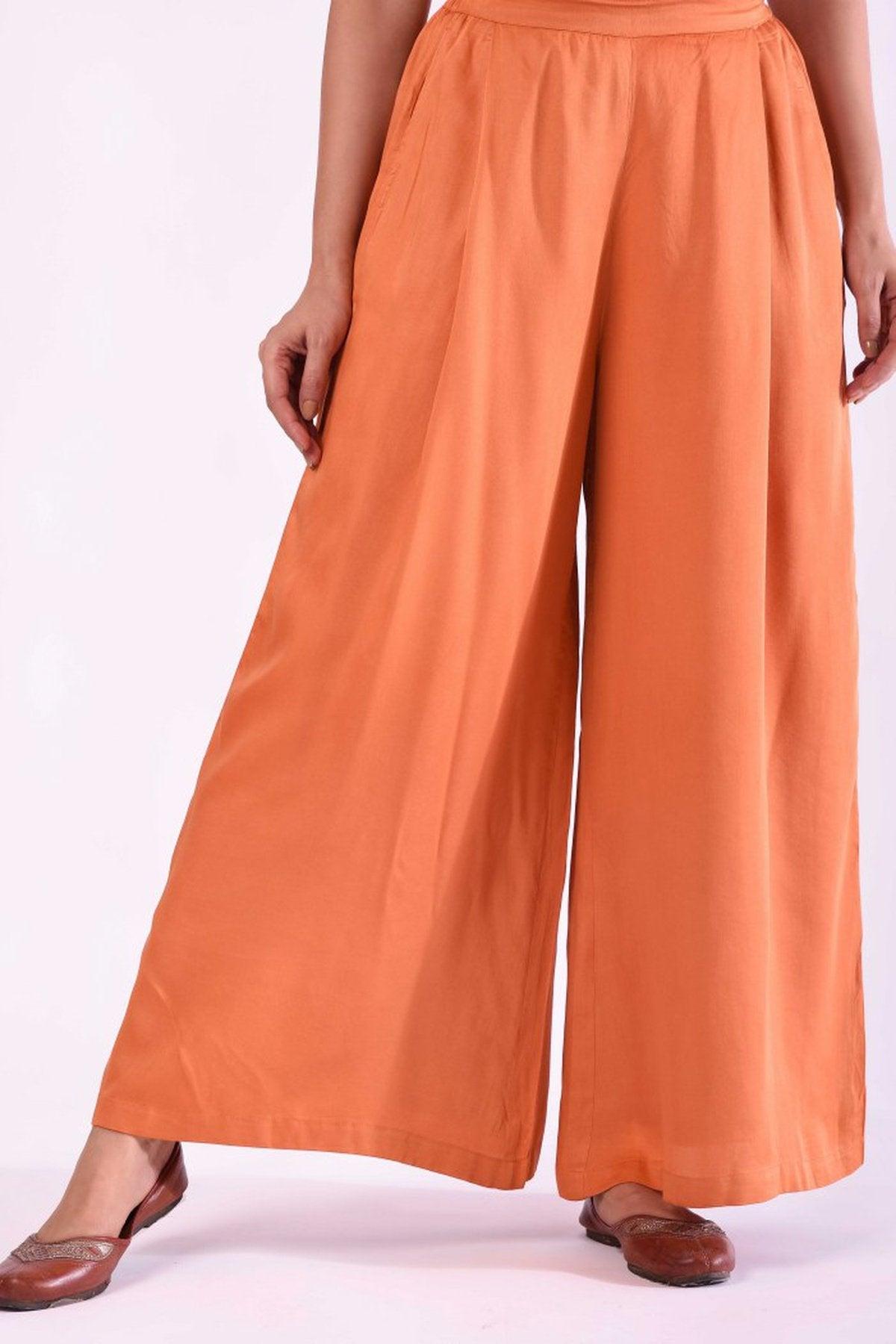 orange pleated pants