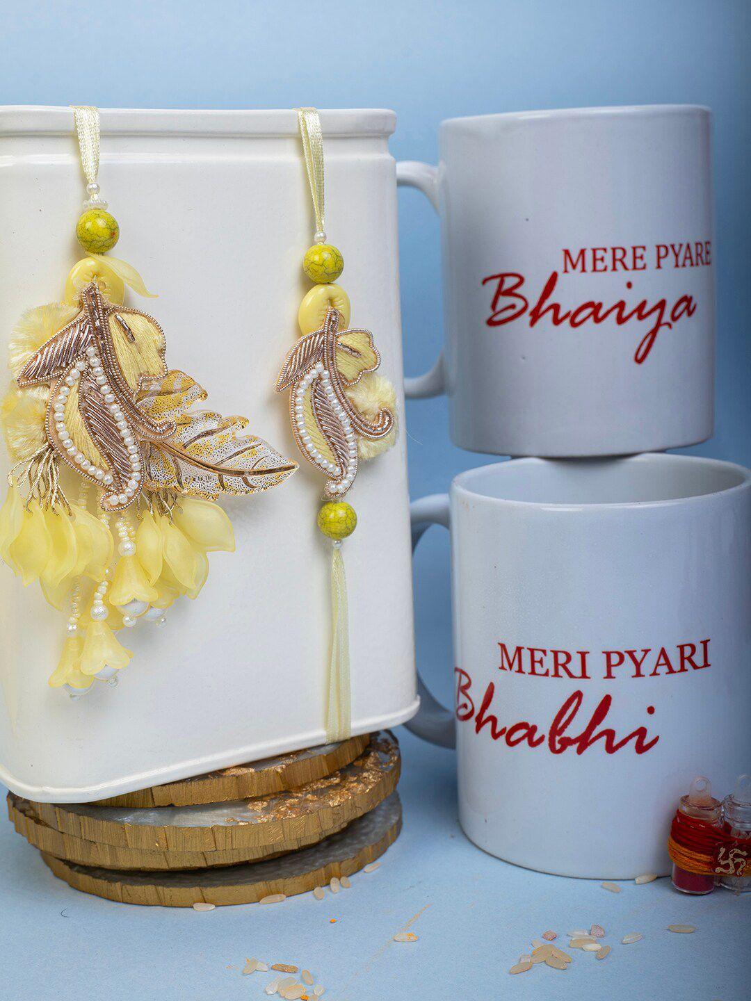 panash set of 2 feather charm rakhi with 2 mugs roli & rice