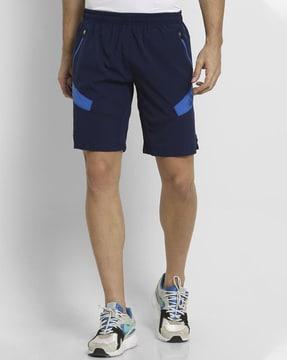panelled mid-rise shorts with zip pockets