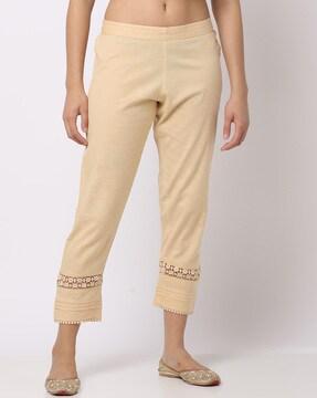 pants with floral lace inserts