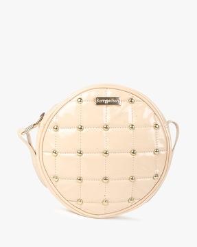 patent round sling bag with rivet embellishment