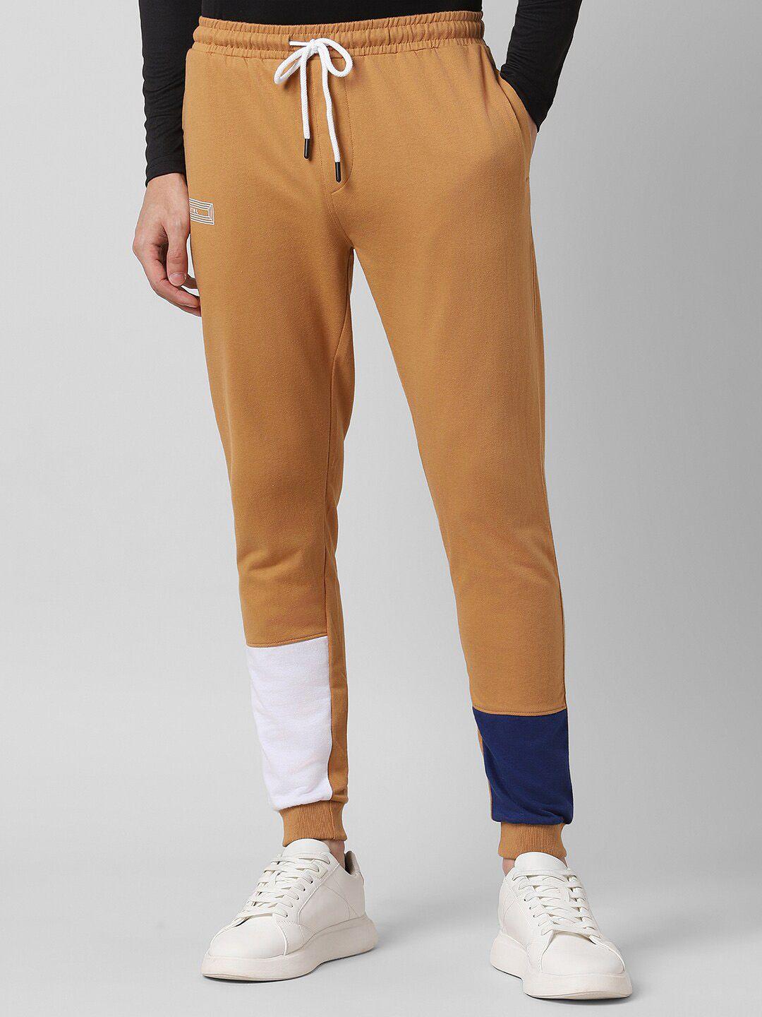 people men rust coloured mid-rise cotton joggers