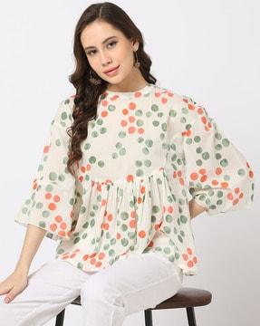 polka-dot print top with bell sleeves