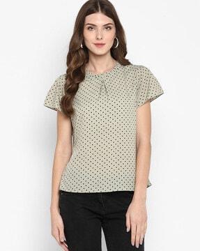 polka-dot top with ruffled neck