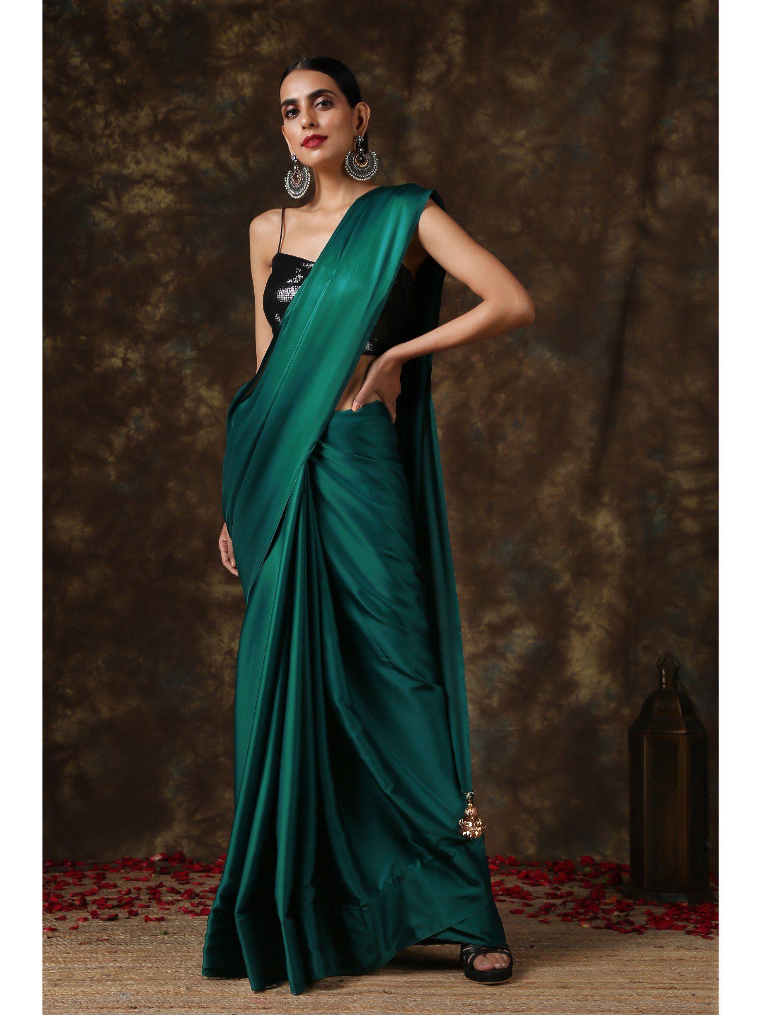 rich emerald green satin saree with bronze tassel pendants