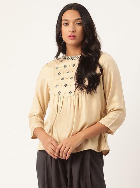 rooted beige embroidered top
