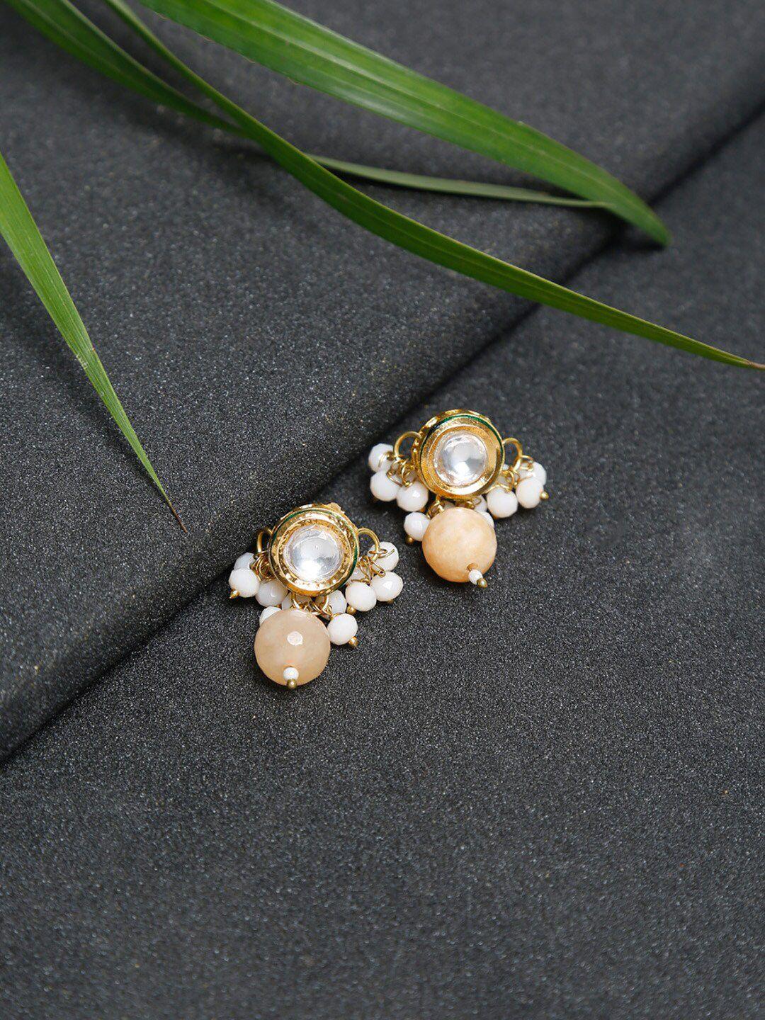 ruby raang gold-toned & peach pearl & kundan studded contemporary studs earrings