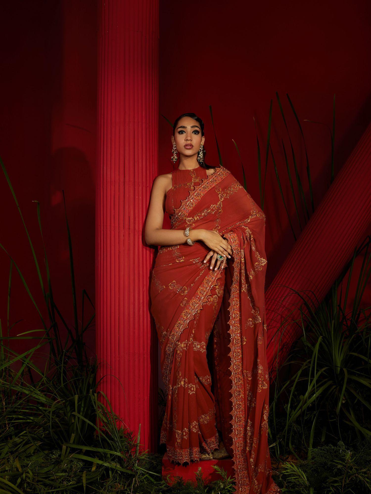 rust saree in georgette silk paired with matching stitched blouse and petticoat