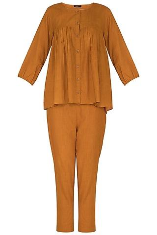 rust top with embroidered buttons & pants