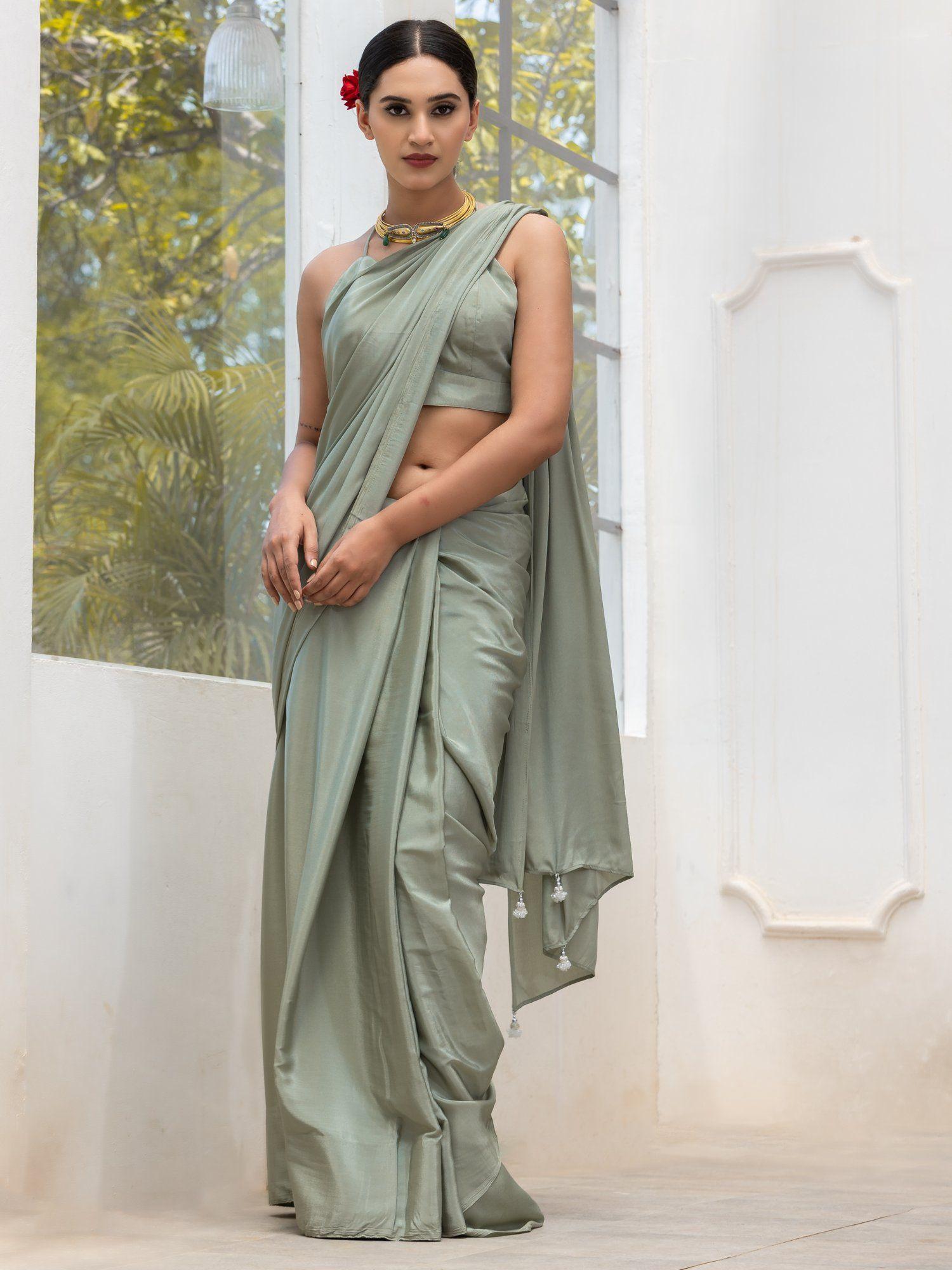 sage crepe saree with silver latkans and unstitched blouse