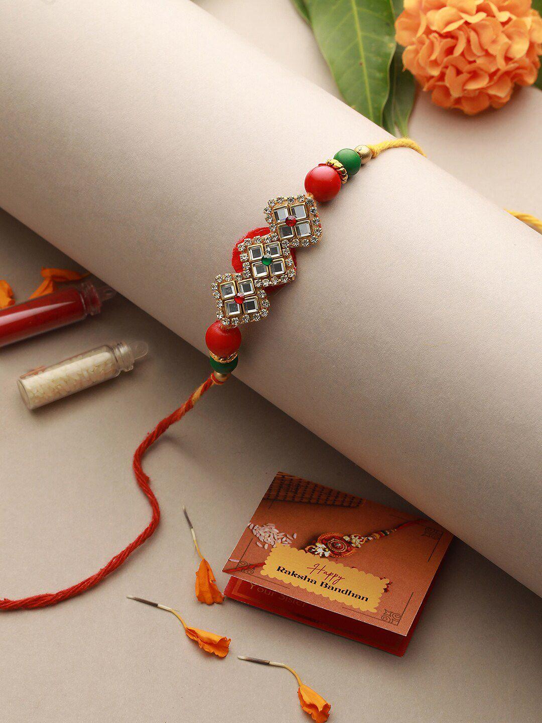 saraf rs jewellery unisex kundan-studded rakhi with roli, rice & greeting card