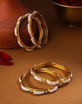 set of 4 gold-plated pearl bangles