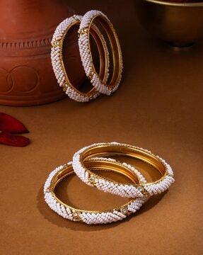 set of 4 gold-plated pearl-studded bangles