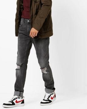 skinny fit distressed jeans with whiskers
