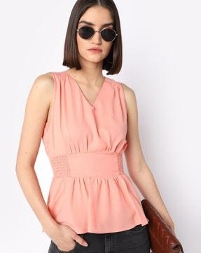 sleeveless peplum top with smocked waist