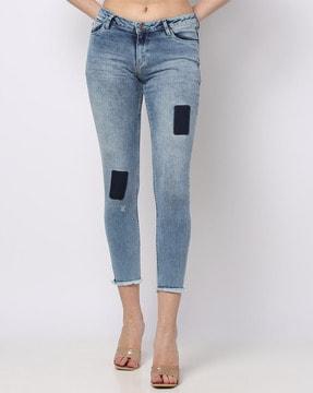slim fit jeans with frayed hemlines