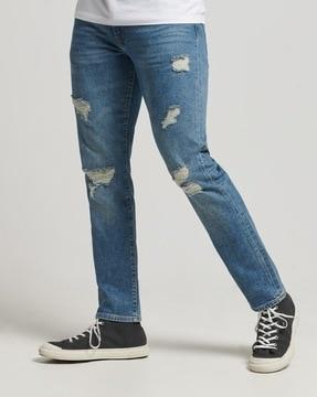 slim fit mid-wash distressed jeans