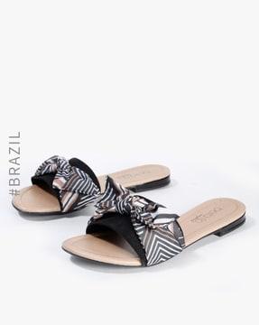 slip-on flat sandals with bow accent