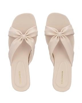 slip-on flat sandals with bow accent