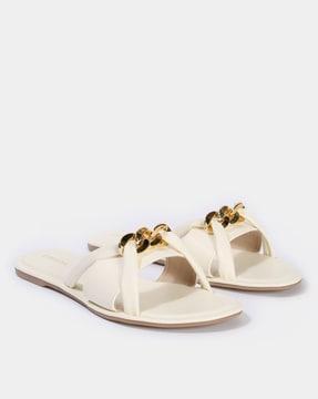 slip-on flat sandals with chain accent