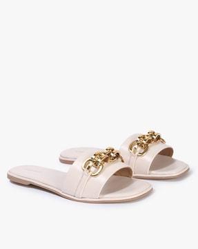 slip-on flat sandals with chain accent