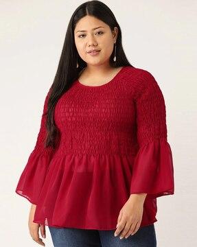 smocked peplum top with bell sleeves