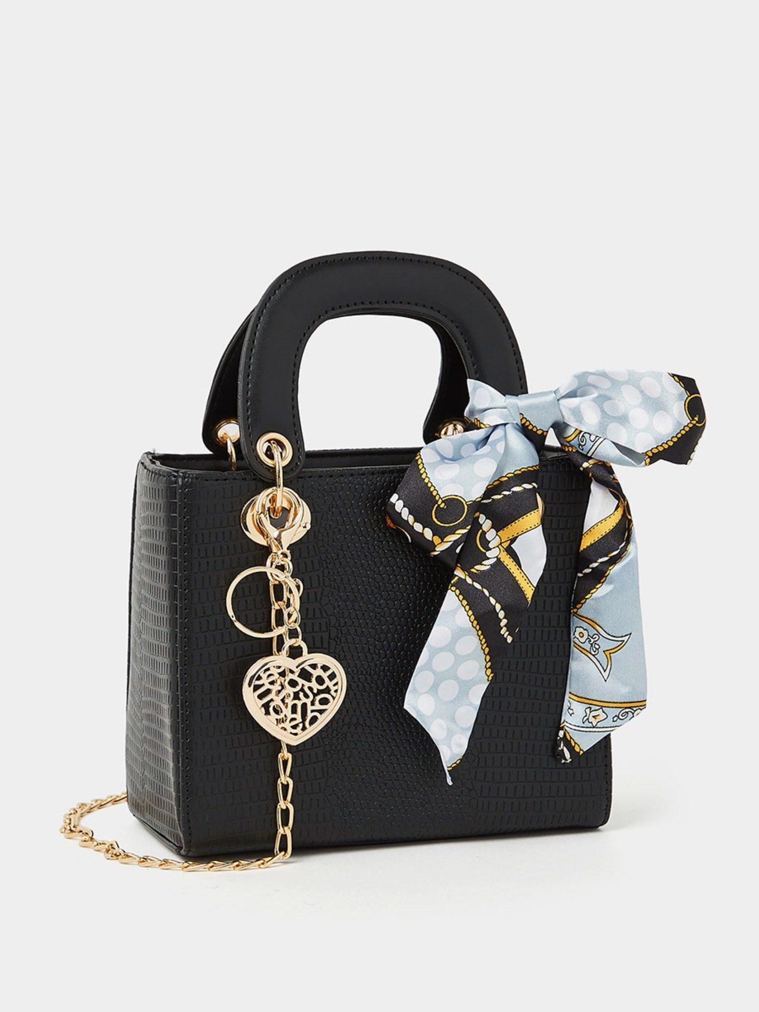 snake skin textured handbag with heart keychain