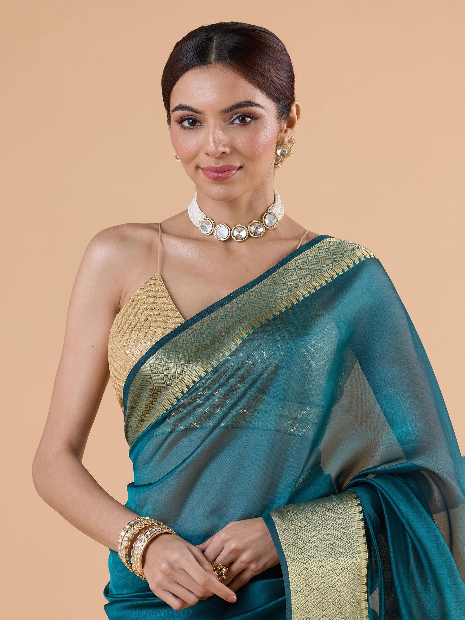 soft light organza with gold zari woven border and tassels teal saree with unstitched blouse