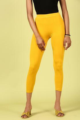 solid ankle length blended fabric women's leggings - mustard