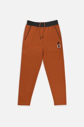 solid cotton regular fit boys track pants - rust