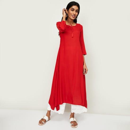 span women solid asymmetric hem kurta with tasselled tie-up