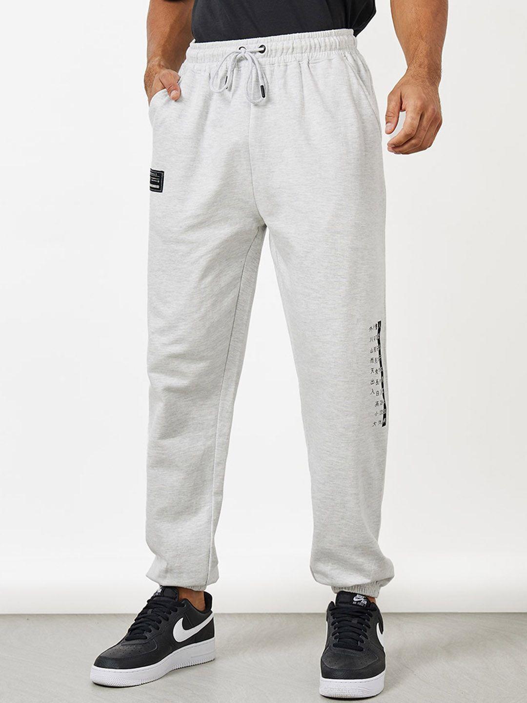 styli men placement print oversized jogger with badge detail