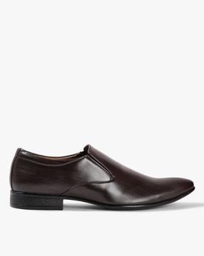 textured slip-on formal shoes with perforations