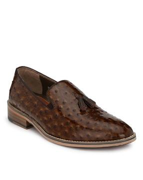 textured slip-on formal shoes with tassels