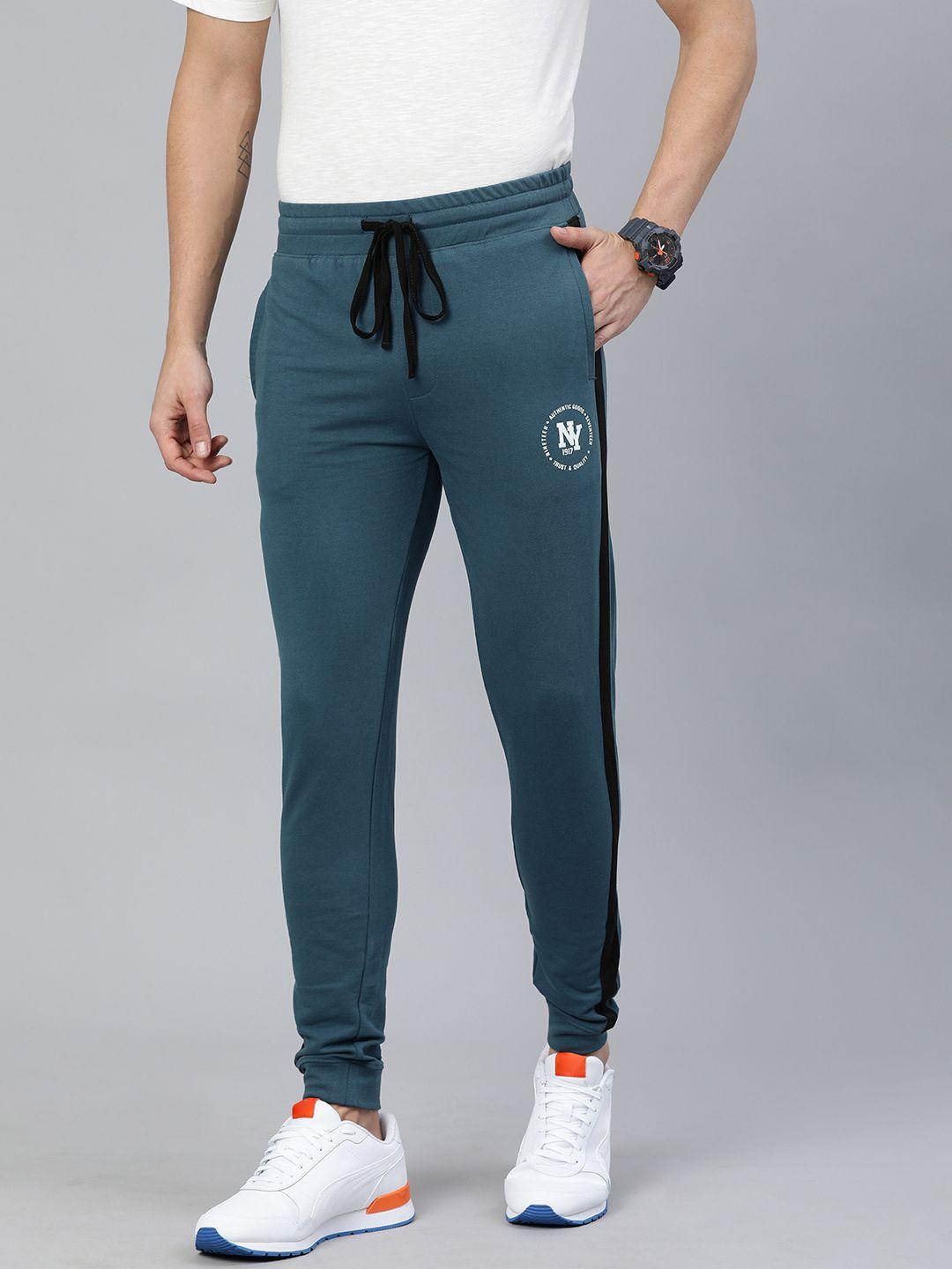 the indian garage co men men teal green solid regular fit joggers with side stripe detail