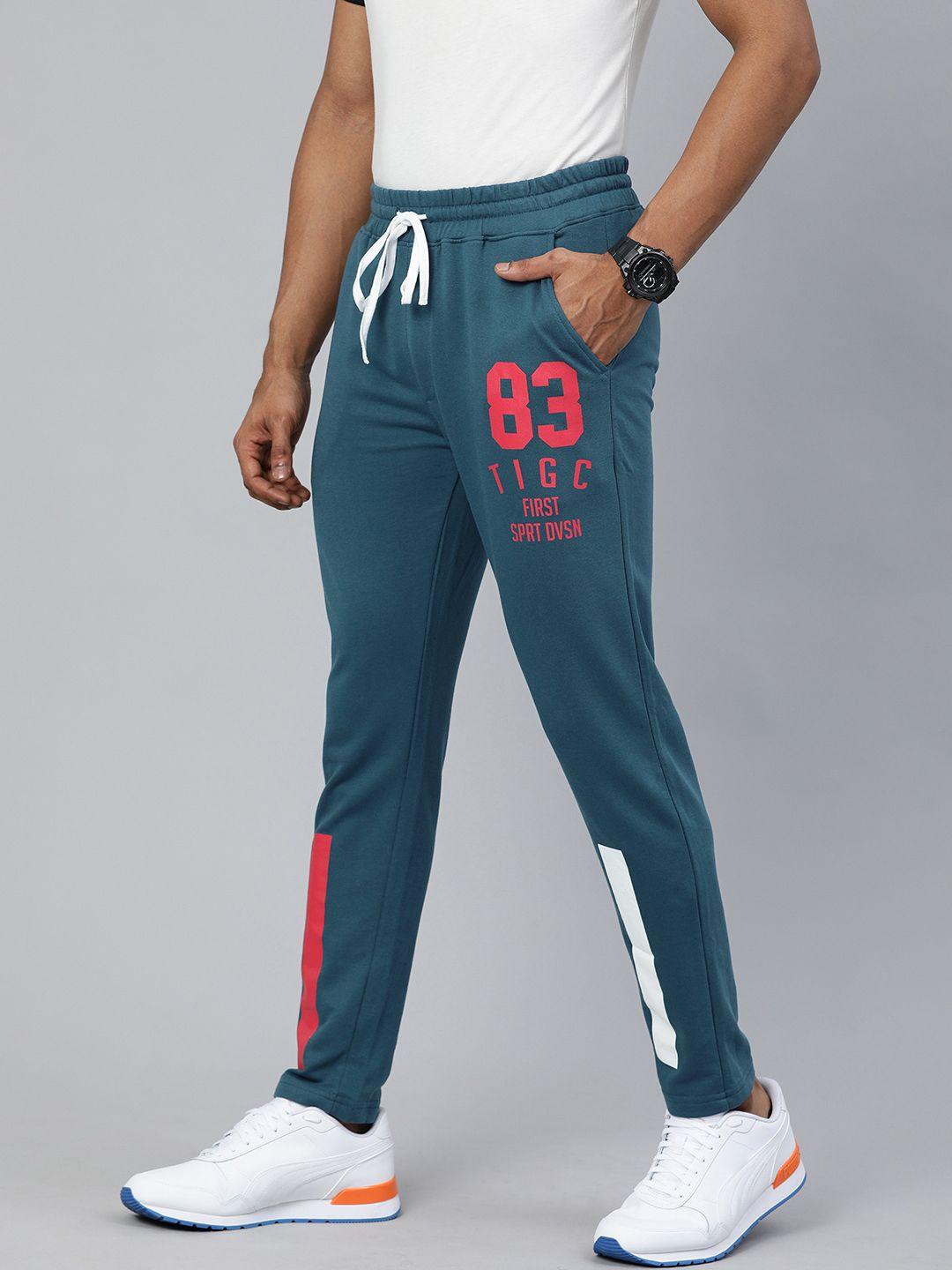 the indian garage co men teal blue solid regular fit track pants with print detail