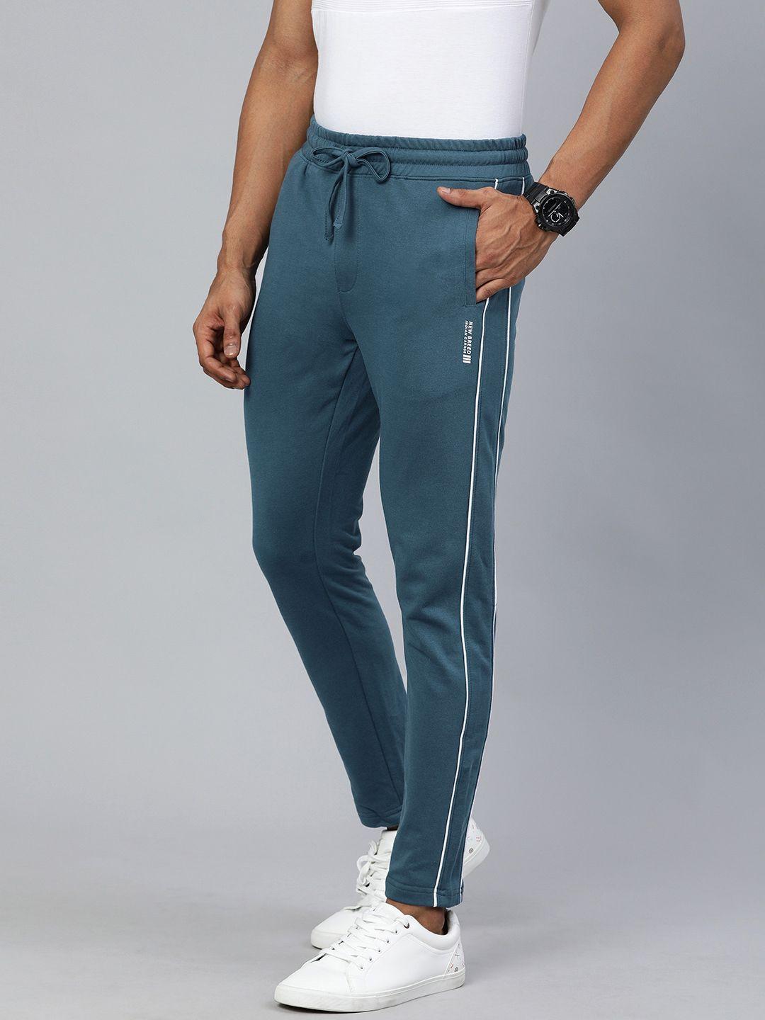 the indian garage co men teal blue solid regular fit track pants with side stripe