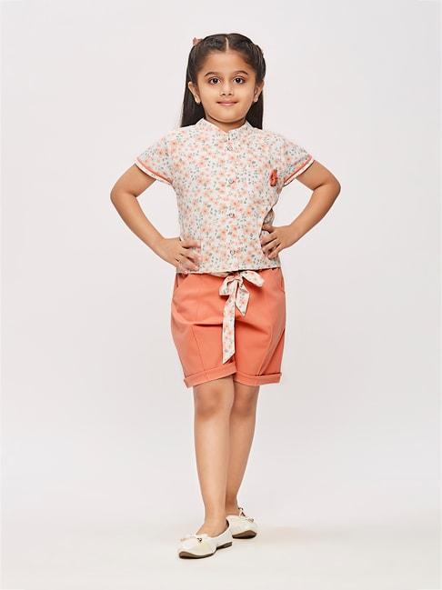 tiny girl white with peach floral print shirt, shorts with belt