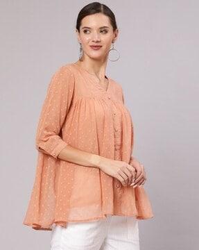 top with flared hemline