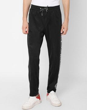 track pants with brand print contrast side taping