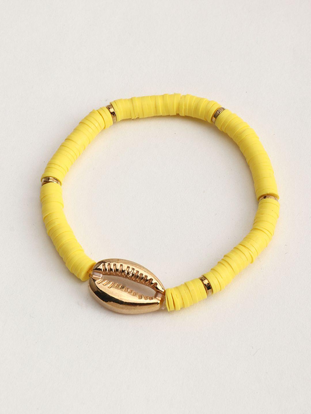 urbanic women yellow & gold-toned cowry detail elasticated bracelet