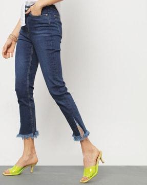 washed high-rise skinny jeans with frayed hems